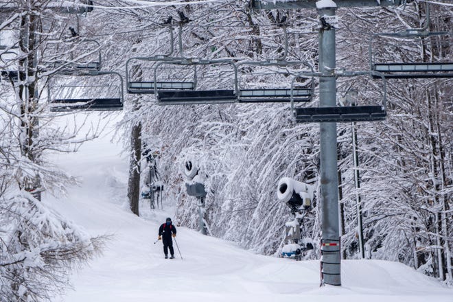 A skier heads to the four-wheel lift at Granite Peak Ski Area in Wausau, December 21, 2022.